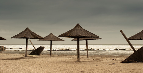 Fototapeta premium Straw umbrellas in the winter