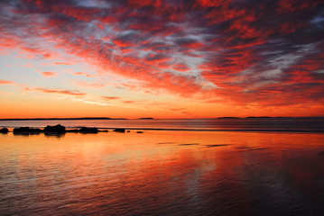 Colorful Sunrise over beach during low tide
