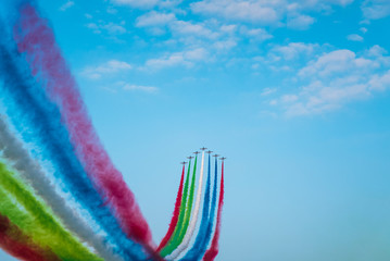 Jet planes leaving colorful trails on the sky during an airshow