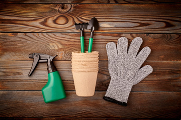 Gardening tools on wooden background flat lay top view