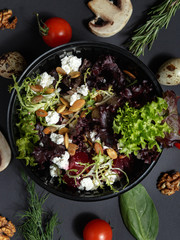 Culinary dishes made from natural products in a plastic bowl on the background with ingredients for cooking. Healthy food delivery concept. Top view.