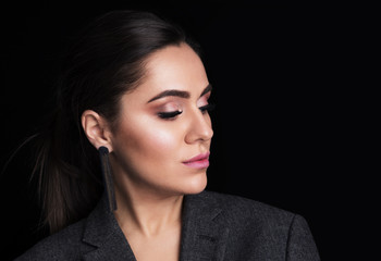 Girl with beautiful makeup and eyes closed on a black background. Beauty concept