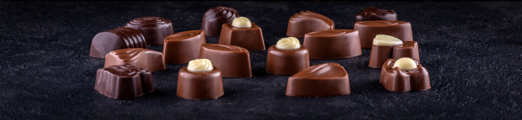 Chocolate pralines on dark background