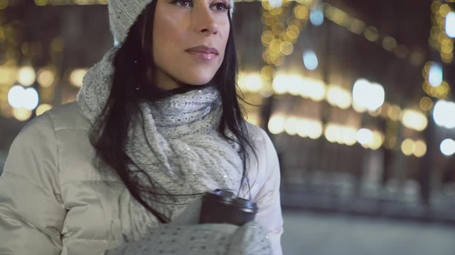 Lady in wool clothing with coffee cup in christmas square.