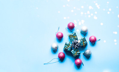 Christmas decorations and gift boxes on blue background. Festive background for decoration or projects. Copy space