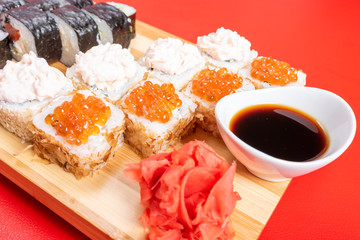 Set of rolls with salmon, red caviar, and flying fish. With krill. Close-up
