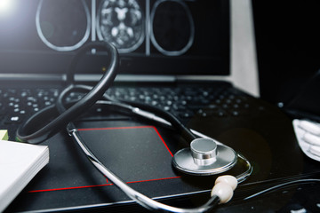 stethoscope and drugs on a computer keyboard. medical pharmaceutical concept.