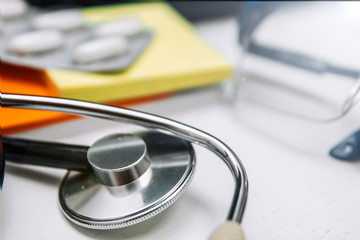 Medical and pharmaceutical concept, antibiotic pills stethoscope on the doctor’s desktop.