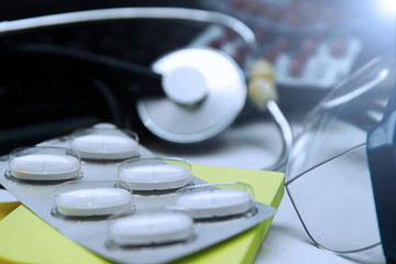 Medical and pharmaceutical concept, antibiotic pills stethoscope on the doctor’s desktop.