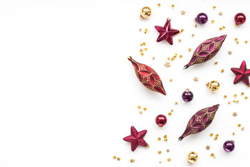 Red and gold christmas decorations on white background, flat lay, top view