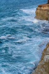 Rocky seaside in windy waves in the mediterranean sea