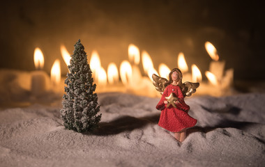 Little white guardian angel in snow. Festive background. Christmas and New Year concept. Selective focus