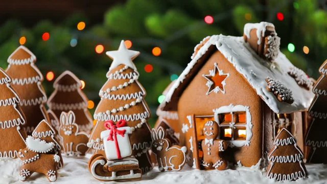 Gingerbread house christmas fir trees Santa Claus and gift cookies winter holiday celebration concept