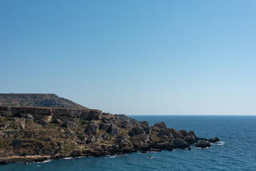 Fototapeta na wymiar Rocks at the sea shore. Ghajn Tuffieha, Golden Bay, Malta. 