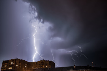 Bright lightning in the black sky over the city