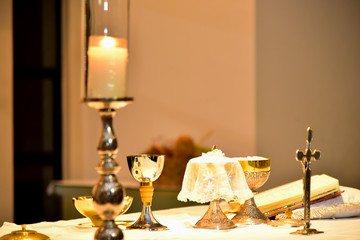 table at the church altar with crucifix and candle