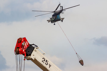Fototapeta na wymiar Obninsk, Russia - September 2019: Civil Defense exercises. Fire extinguishing from a helicopter Mi-8MT