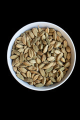 Small bowl of cardamom pods