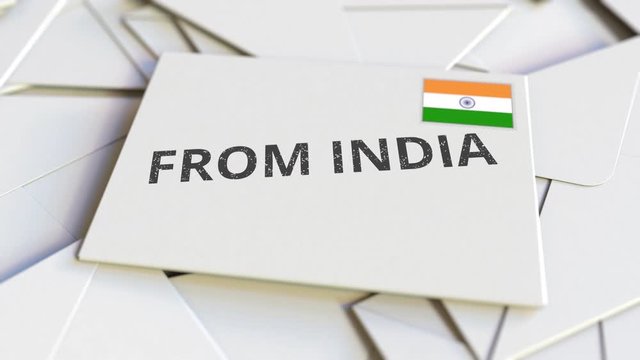 Envelope with From India text on pile of other envelopes. International mail related conceptual 3D animation