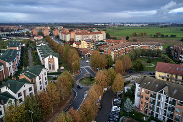 Aerial view of Turin. Little district of Turin Torino in bright autumn day. Orange trees, buildings, roads and cars.