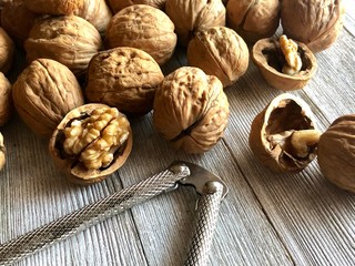 walnuts and nutcracker on wooden background
