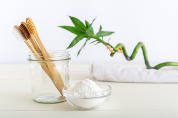 Bamboo toothbrushes, dentifrice tooth powder on white background. Natural bath products, bamboo plant.Biodegradable natural bamboo toothbrush.Eco friendly, Zero waste, Dental care Plastic free concept