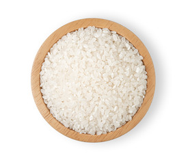 Rice in a wooden cup on a white background.