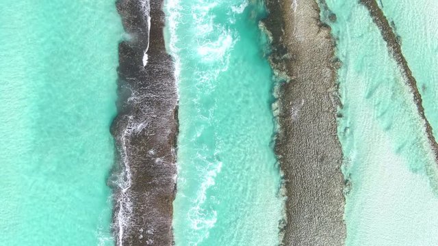 Top-down aerial shots of beautiful rock formation and beaches with crystal clear blue water in Esperance, Western Australia.