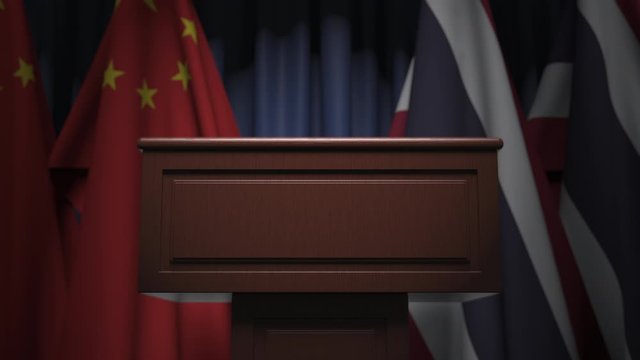Flags of China and Thailand and speaker podium tribune. Political event or negotiations related conceptual 3D animation