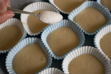 view of a teaspoon with sugar to put in the homemade muffins