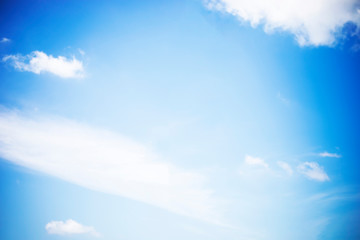 Blue sky background and white clouds soft focus, and copy space