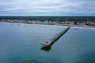 Aerial view of Ocean crest fishing pier at Oak Island NC. Looking at the pier and beach front.
