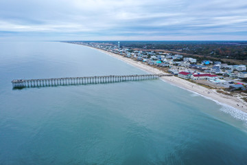 Aerial view of Ocean crest fishing pier at Oak Island NC. Looking at the pier and beach front.