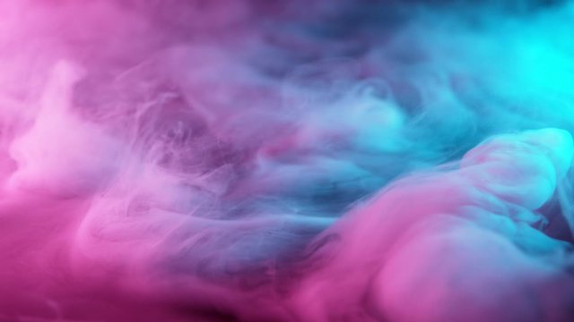 Slow motion of coloured smoke effect with neon lights