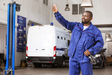 African-American mechanic working in car service center