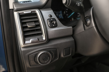 Fototapeta na wymiar Air conditioner and lighting control buttons in modern car