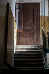 Old wooden door in the porch. Flight of stairs