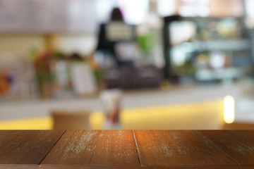 Empty dark wooden table in front of abstract blurred bokeh background of restaurant . can be used for display or montage your products.Mock up for space.