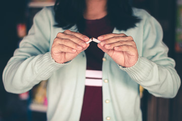 The hand held a cigarette to crush smoke of a burning, Stop smoking concept.