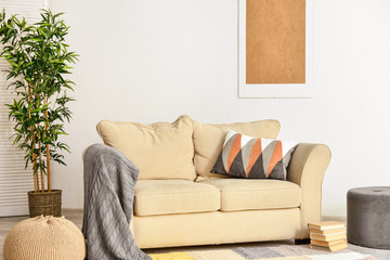 Stylish interior of room with comfortable sofa