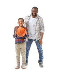 Portrait of African-American man and his little son with ball on white background