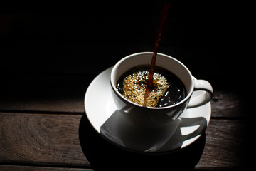 A coffee cup on a dark wooden background
