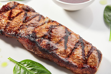 Striploin steak with sauce close up