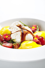Exquisite serving burrata cheese with tomatoes and mango mousse