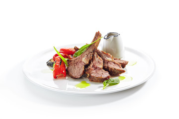 Grilled Lamb Rack with Baked Vegetables on White Restaurant Plate