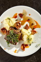 Beef brisket and mashed potato on white plate
