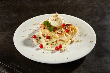 Apple pie slice with ice cream scoop side view