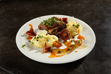 Beef brisket and mashed potato on white plate