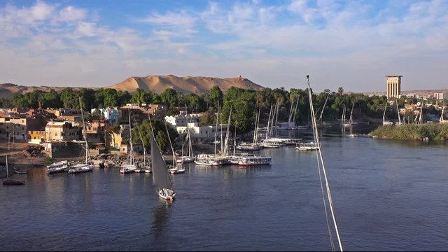Beautiful landscape with felucca boats on Nile river in Aswan at sunset, Egypt, 4k