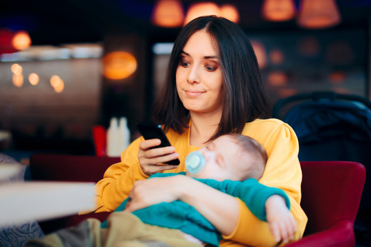 Bored Mother Checking Smartphone While Baby Is Sleeping